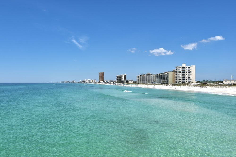 buildings near body of water under blue sky